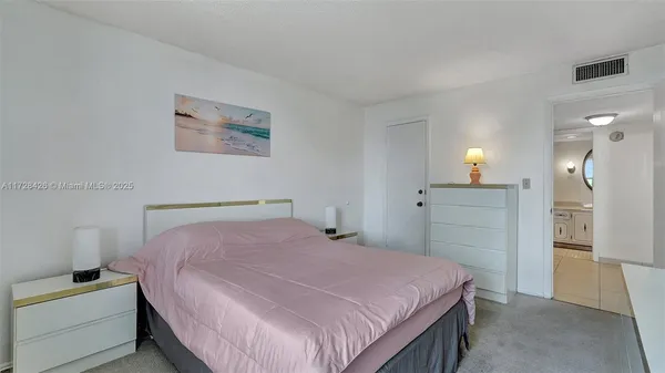 a bedroom with a bed and a cabinets