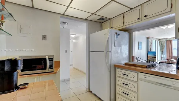 a kitchen with stainless steel appliances granite countertop a refrigerator and a stove