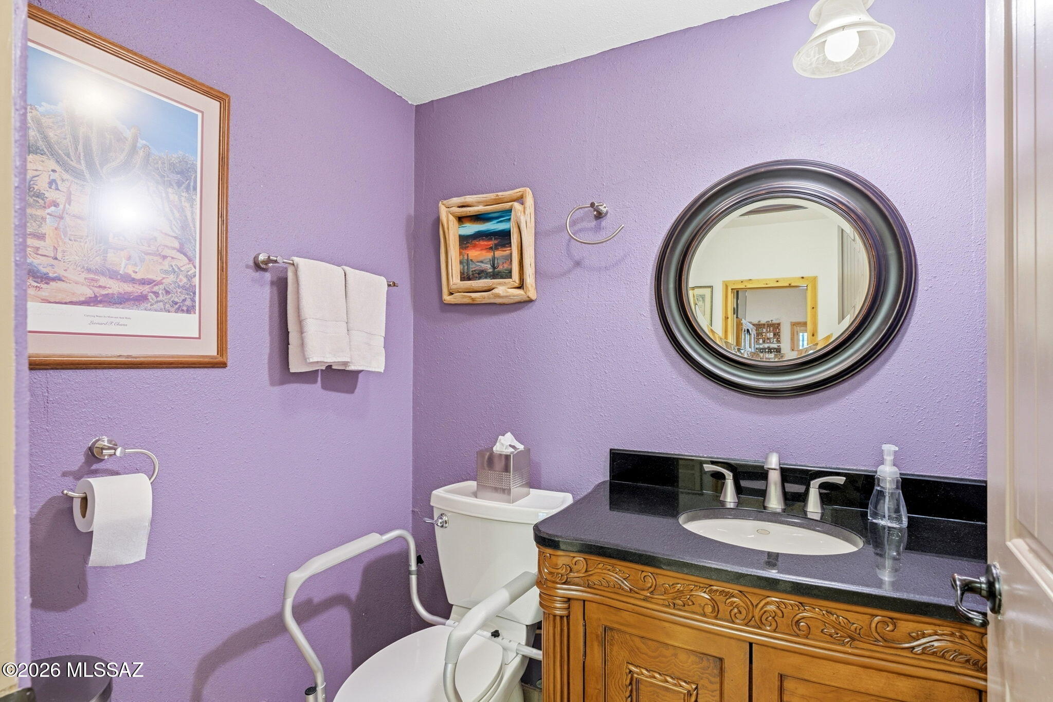 12810 West Gunsmoke Road Tucson, AZ 85736 - Photo 25 of 51 a bathroom with a granite countertop toilet a sink and mirror