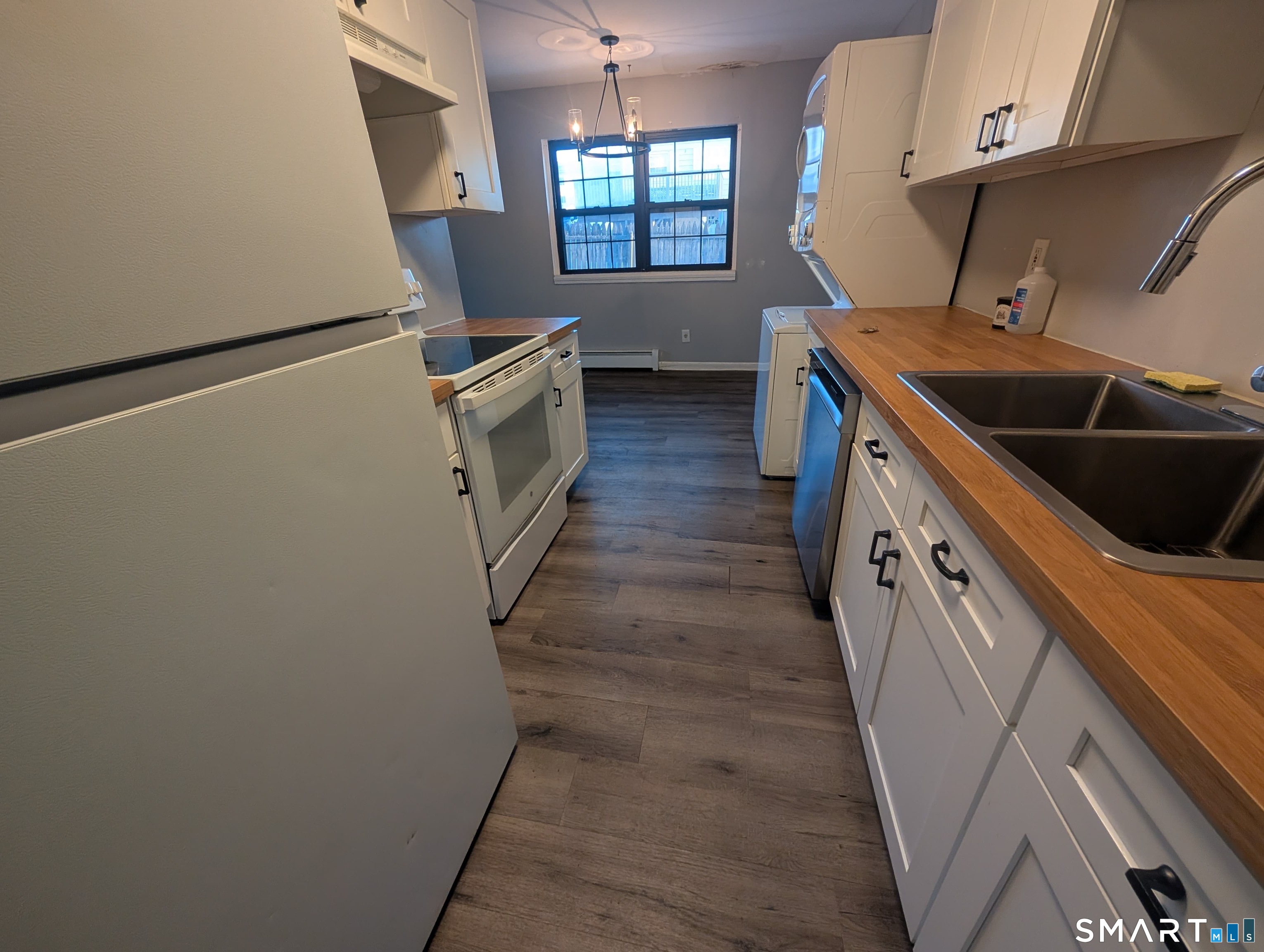 21 Enid Street, Unit A Bridgeport, CT 06606 - Photo 2 of 10 a kitchen with granite countertop a sink a stove a washer and dryer