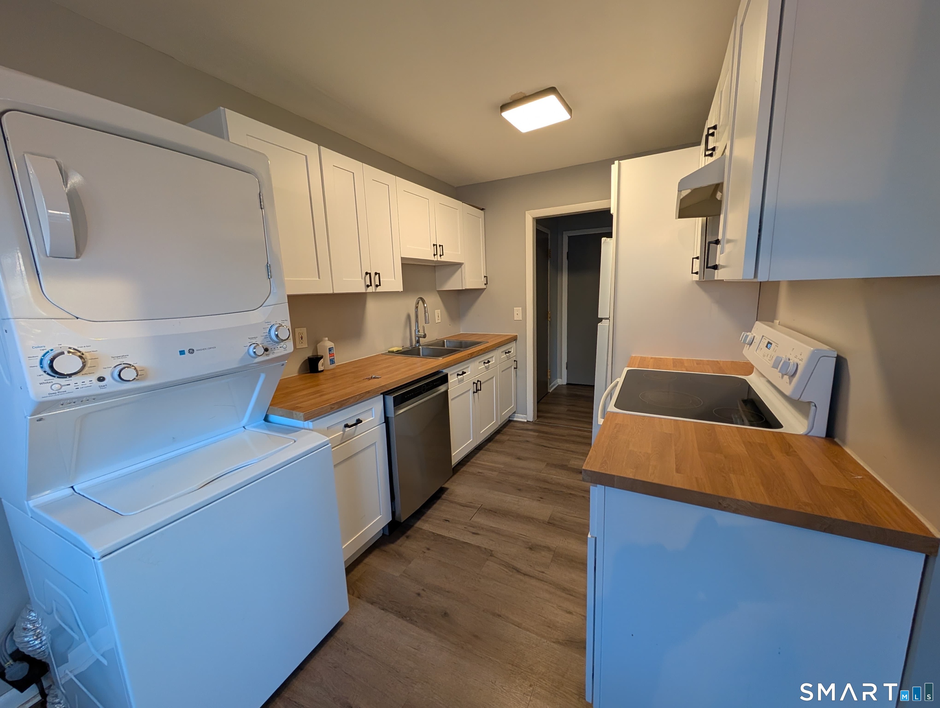 21 Enid Street, Unit A Bridgeport, CT 06606 - Photo 3 of 10 a kitchen with stainless steel appliances granite countertop a sink a stove and a refrigerator