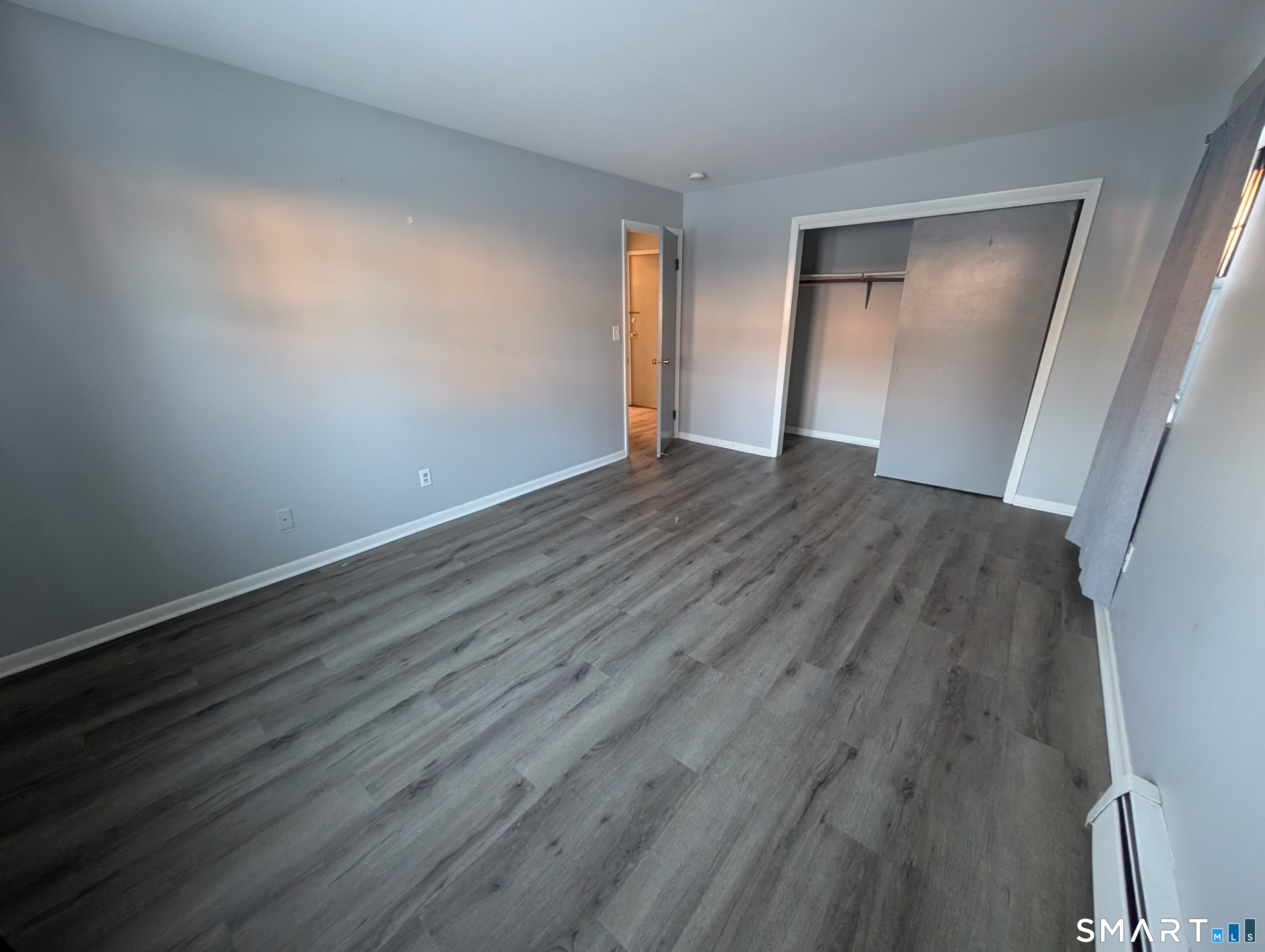 21 Enid Street, Unit A Bridgeport, CT 06606 - Photo 8 of 10 wooden floor in an empty room