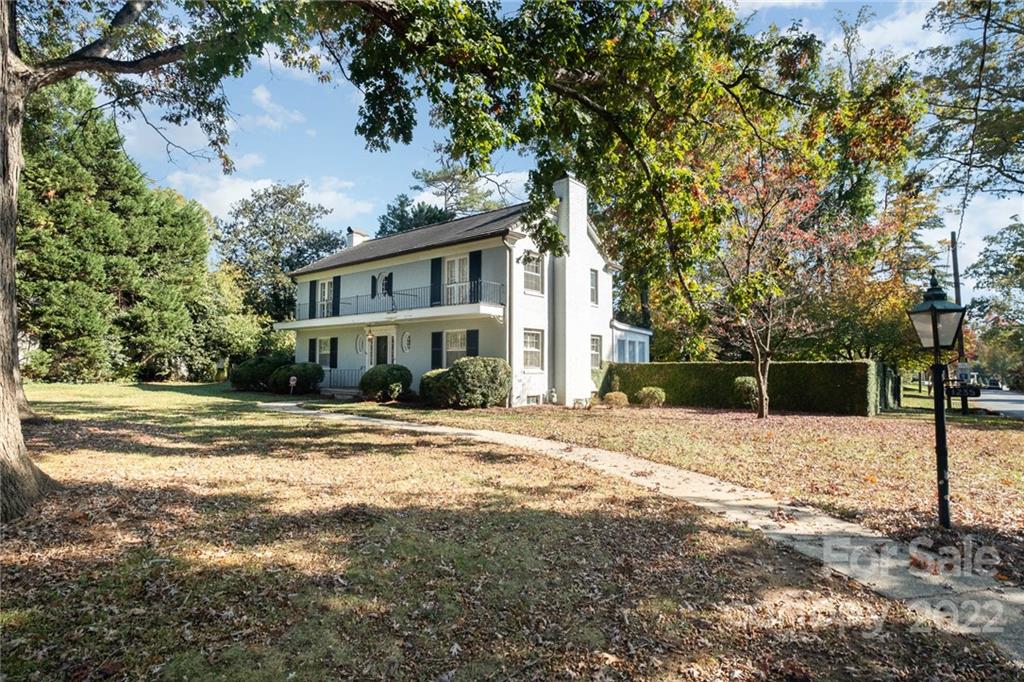 1235 South Wendover Road Charlotte, NC 28211 - Photo 1 of 39 a front view of a house with a yard and garage