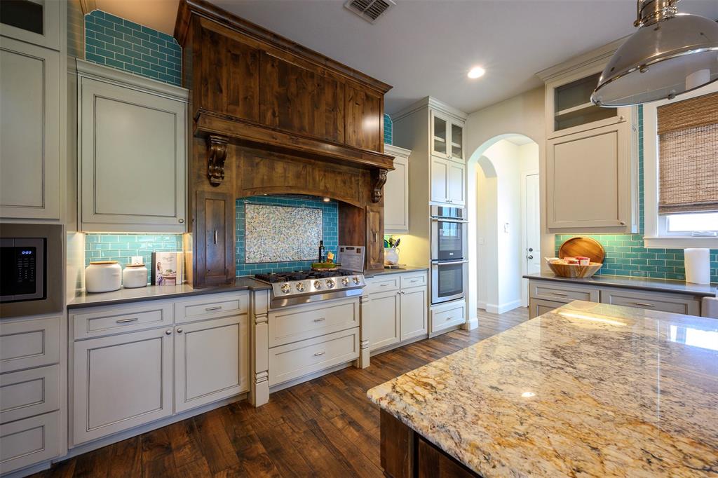 1003 Buckner Road Lipan, TX 76462 - Photo 11 of 31 a kitchen with stainless steel appliances kitchen island granite countertop a stove refrigerator and cabinets