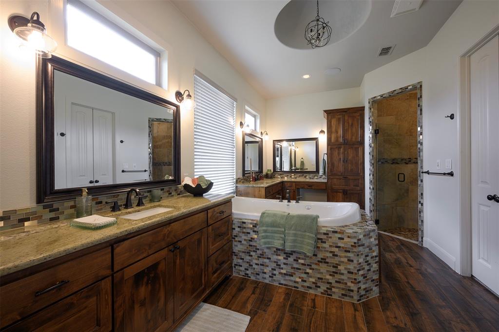 1003 Buckner Road Lipan, TX 76462 - Photo 13 of 31 a bathroom with a double vanity sink a mirror and a shower
