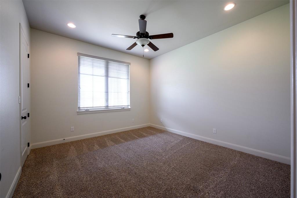 1003 Buckner Road Lipan, TX 76462 - Photo 16 of 31 en empty room with windows and ceiling fan