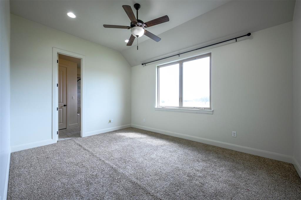1003 Buckner Road Lipan, TX 76462 - Photo 24 of 31 an empty room with a chandelier fan and windows