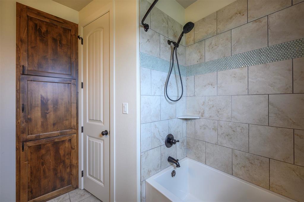 1003 Buckner Road Lipan, TX 76462 - Photo 26 of 31 a bathroom with a shower and a bathtub