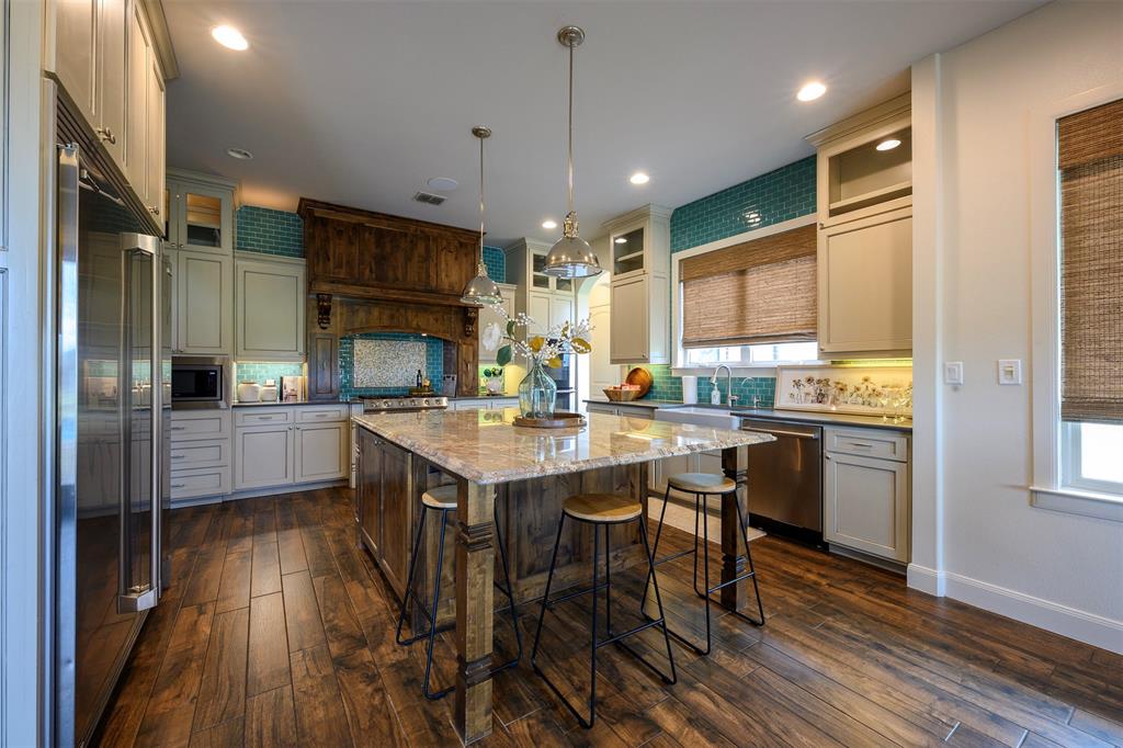 1003 Buckner Road Lipan, TX 76462 - Photo 10 of 31 a kitchen with kitchen island granite countertop a sink cabinets and stainless steel appliances