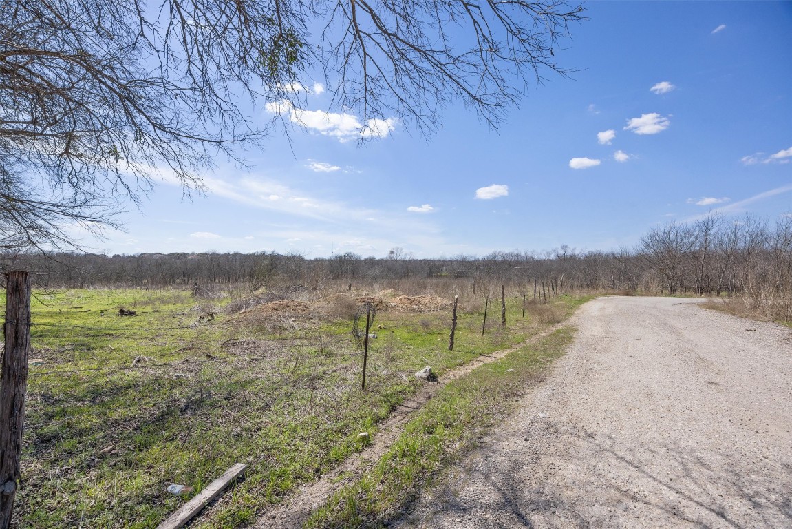 940 Windy Hill Road Kyle, TX 78640 - Photo 9 of 12 a view of a lake with a yard and mountain view