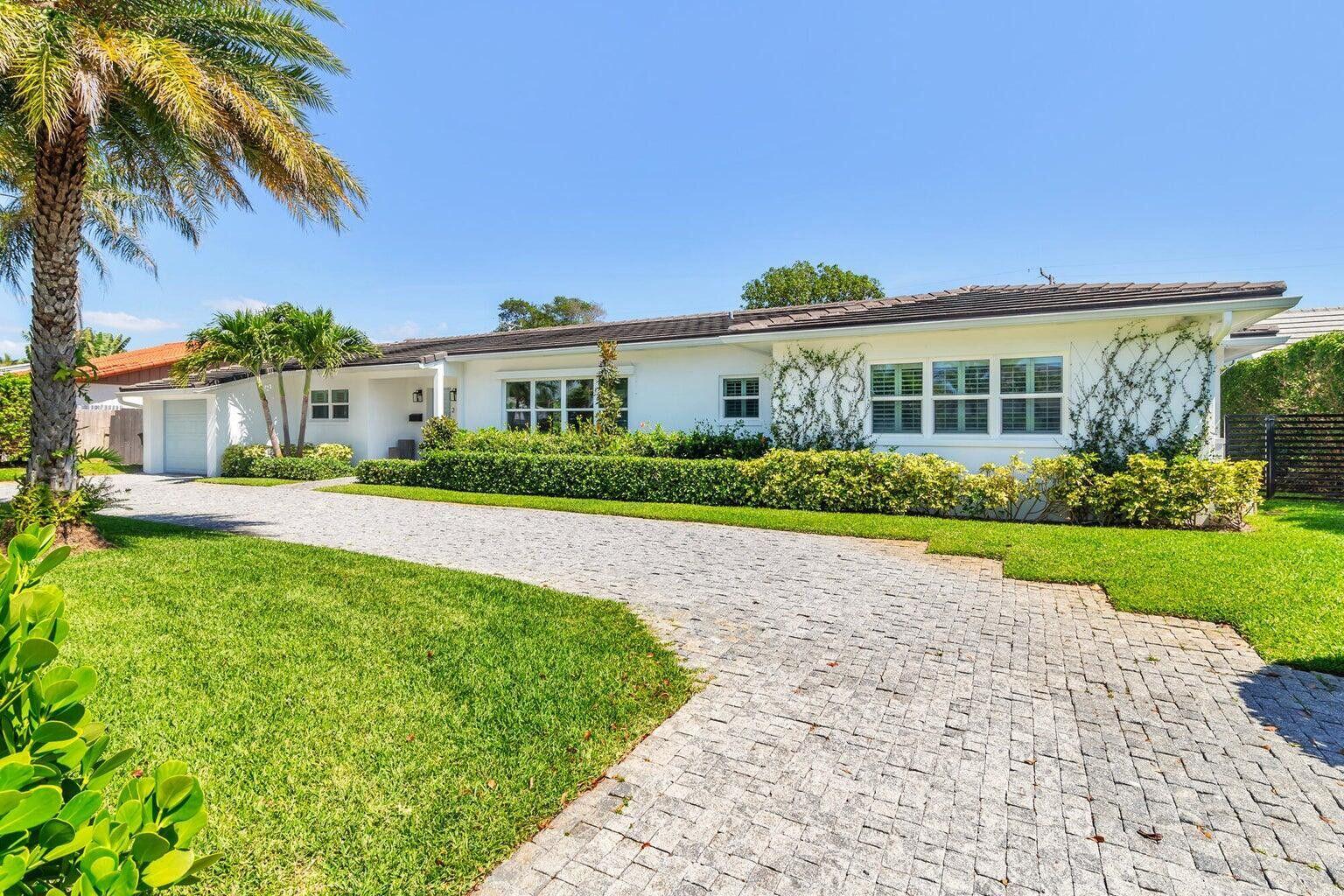215 Cortez Road West Palm Beach, FL 33405 - Photo 1 of 17 a front view of a house with a yard and potted plants