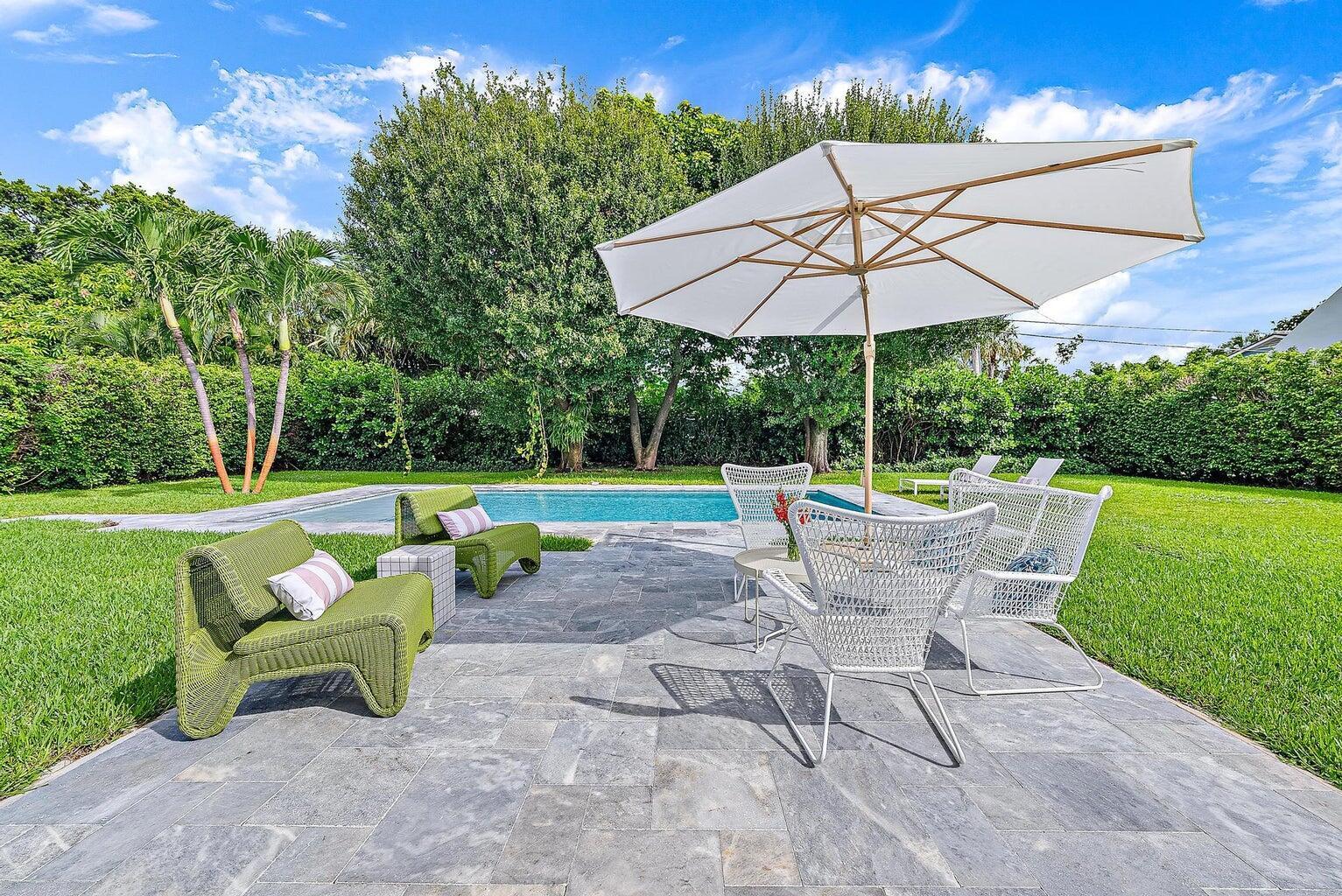 215 Cortez Road West Palm Beach, FL 33405 - Photo 12 of 17 a view of a table and chairs under an umbrella