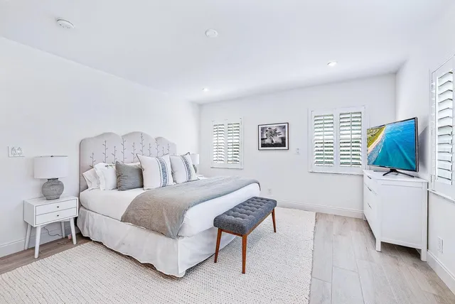 a bedroom with a bed and a flat screen tv