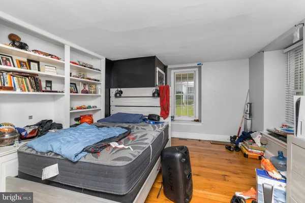 a living room with furniture a rug and a book shelf