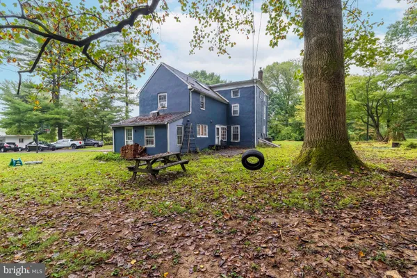 a front view of a house with yard and green space