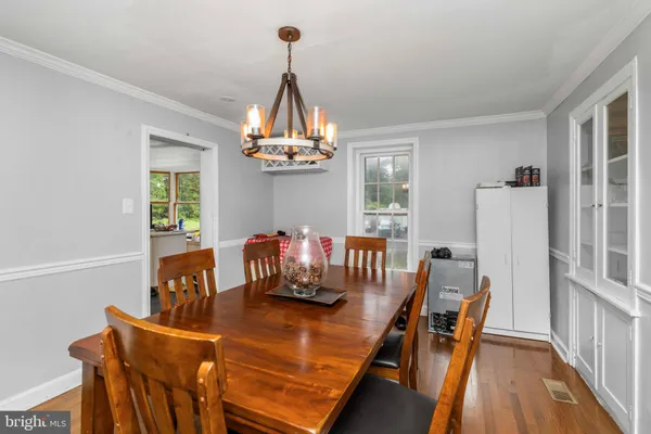 a view of a dining room with furniture and chandelier