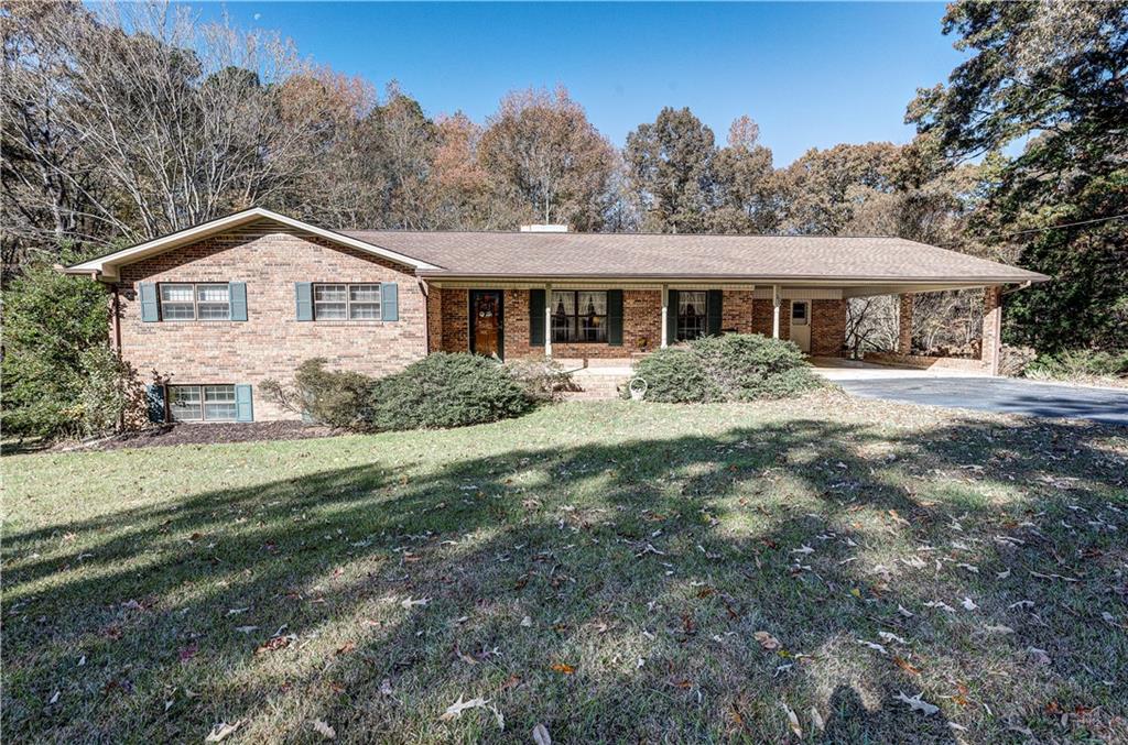 390 Foster Lusk Road Southeast Calhoun, GA 30701 - Photo 1 of 1 a front view of a house with a garden