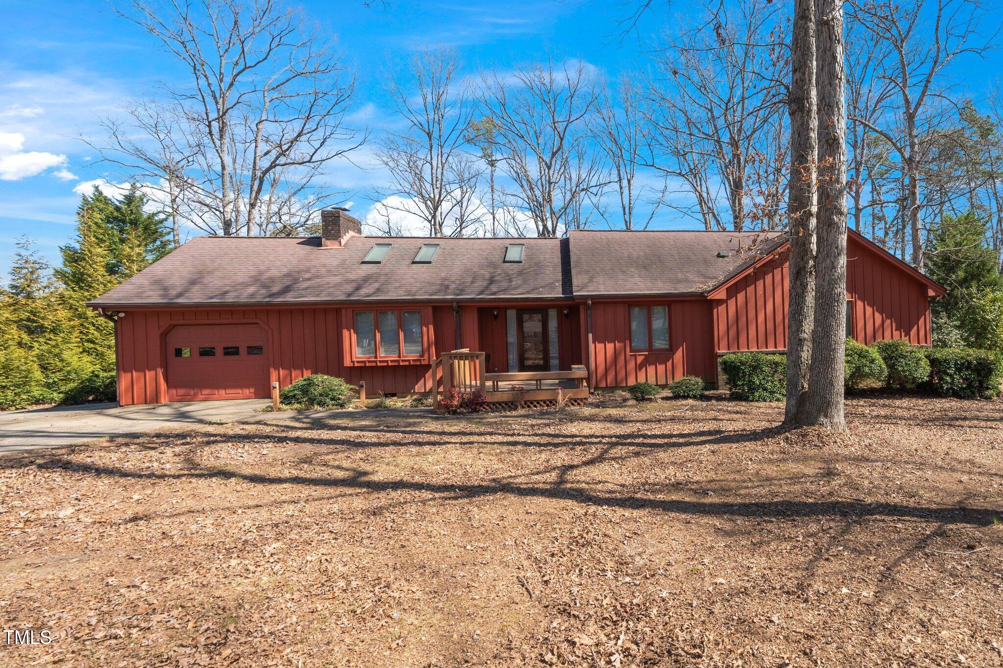 a view of a house with a yard and tree s