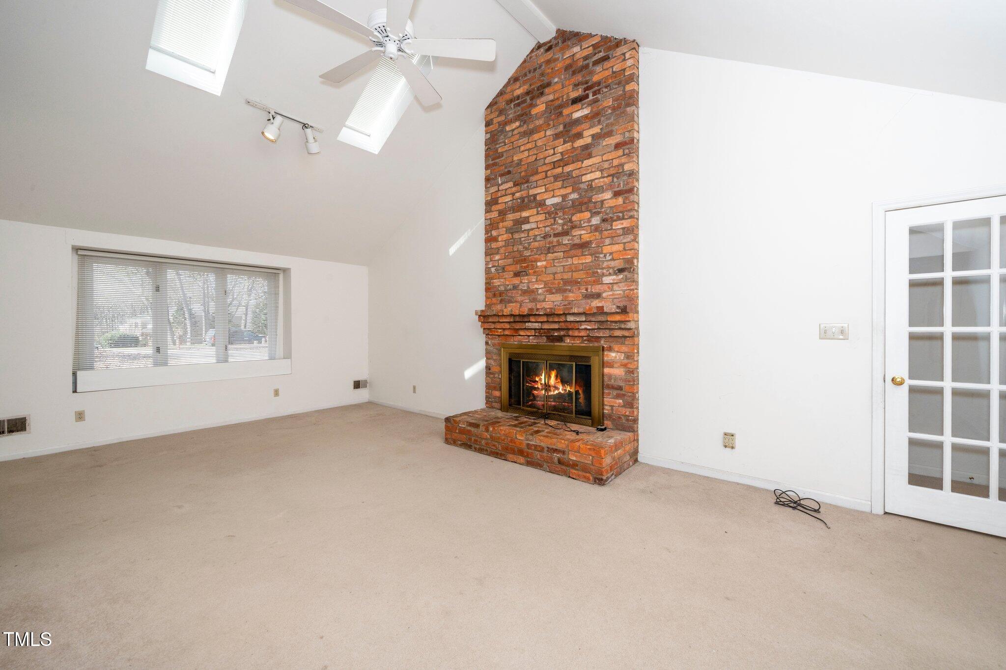 6312 New Market Way Raleigh, NC 27615 - Photo 11 of 31 an empty room with windows and fireplace