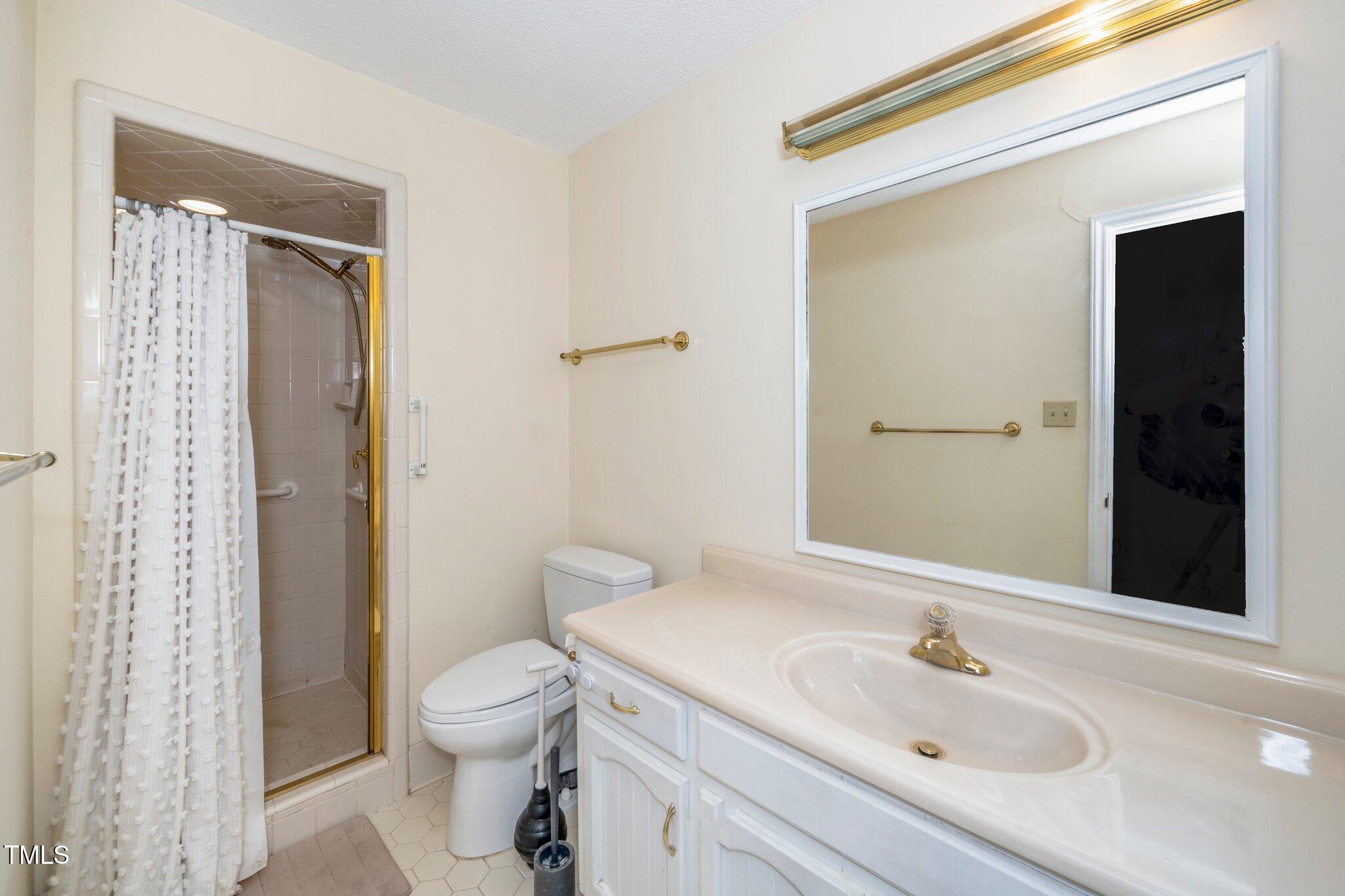 6312 New Market Way Raleigh, NC 27615 - Photo 26 of 31 a bathroom with a sink toilet and shower