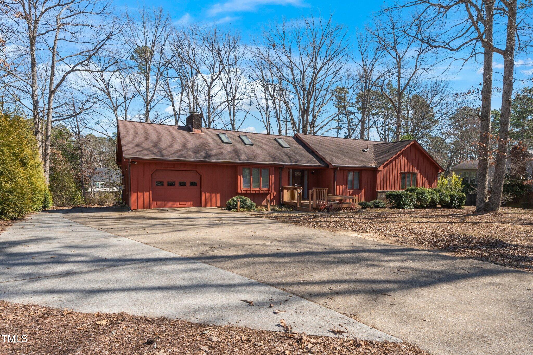 6312 New Market Way Raleigh, NC 27615 - Photo 6 of 31 a front view of a house with a garden and trees