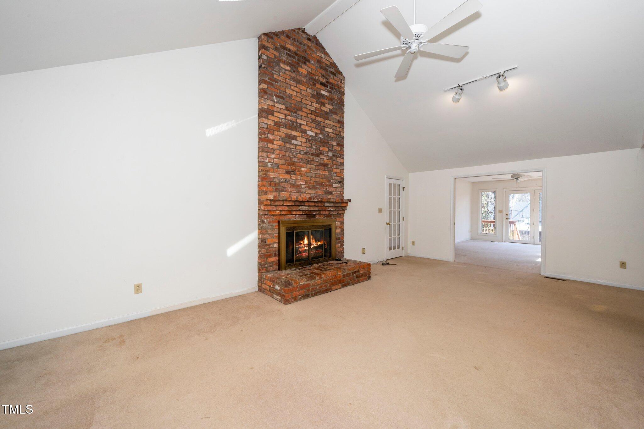 6312 New Market Way Raleigh, NC 27615 - Photo 9 of 31 an empty room with windows and fireplace