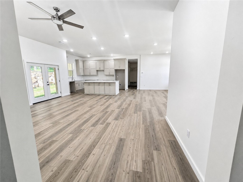 331 Channel Circle Russellville, AR 72802 - Photo 19 of 29 Expansive open-concept space featuring wood-finish flooring, recessed lighting, and a contemporary ceiling fan