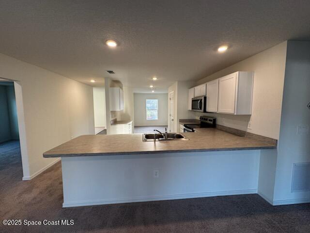 1349 Gibbs Road Southwest Palm Bay, FL 32908 - Photo 4 of 9 a view of kitchen with stainless steel appliances granite countertop a sink a stove and a refrigerator