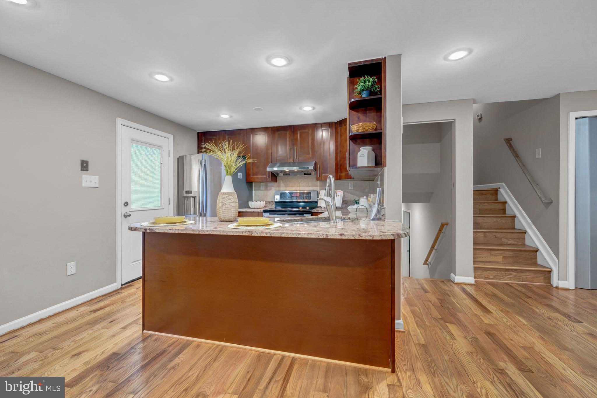 12772 Bradwell Road Herndon, VA 20171 - Photo 11 of 43 a view of kitchen with cabinets and wooden floor