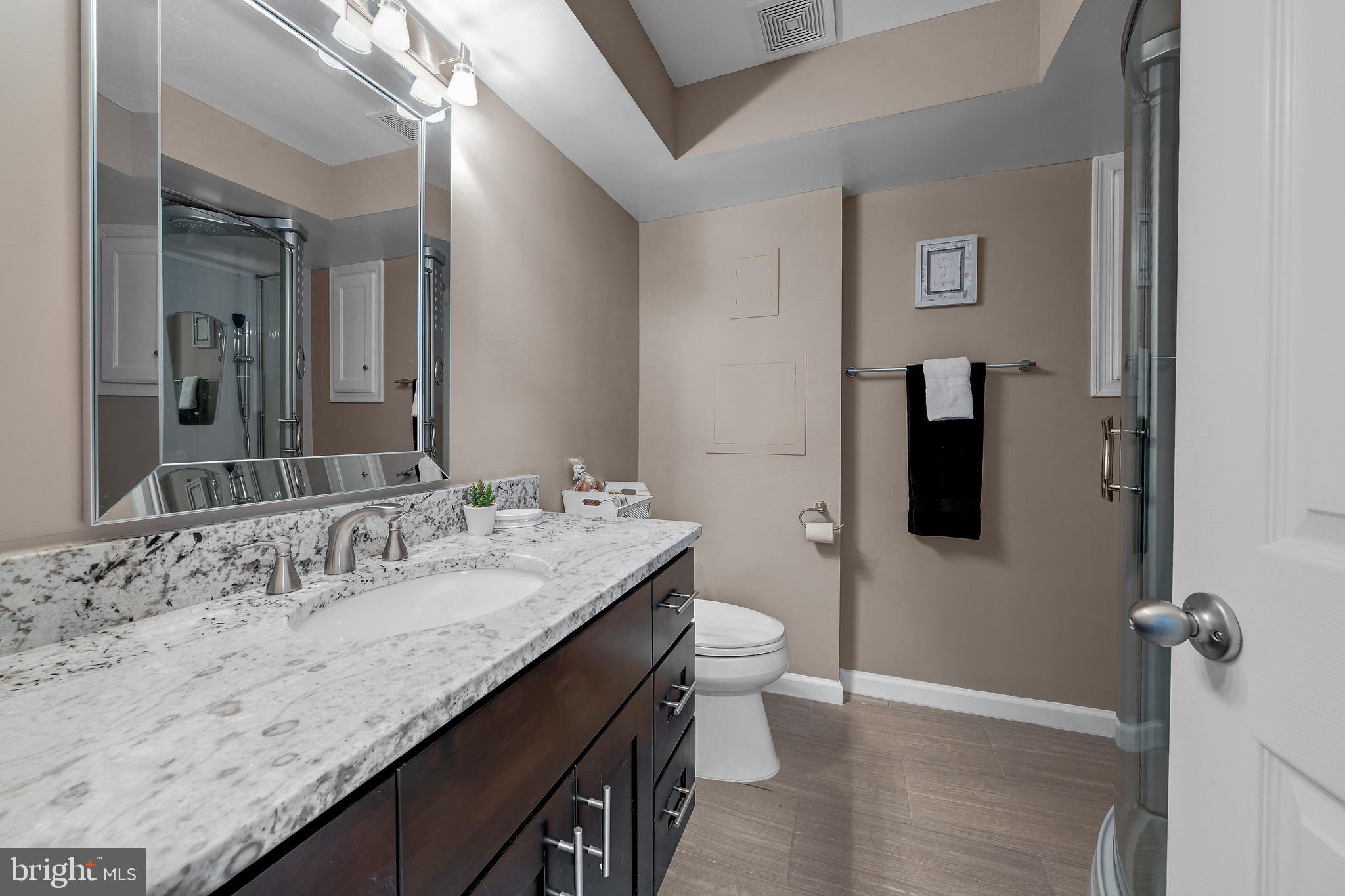 12772 Bradwell Road Herndon, VA 20171 - Photo 17 of 43 a bathroom with a granite countertop sink and a mirror