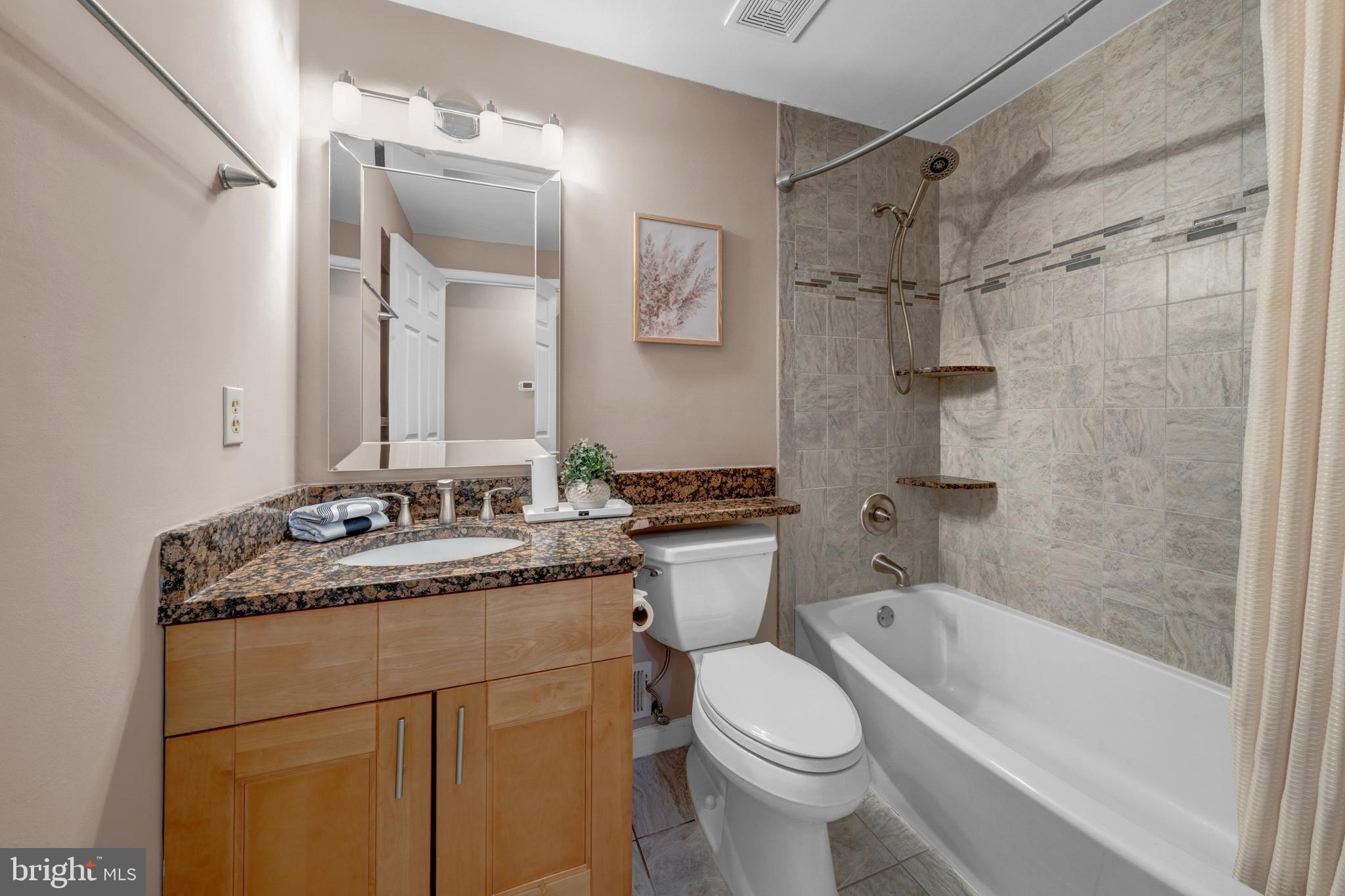 12772 Bradwell Road Herndon, VA 20171 - Photo 19 of 43 a bathroom with a granite countertop sink toilet and shower