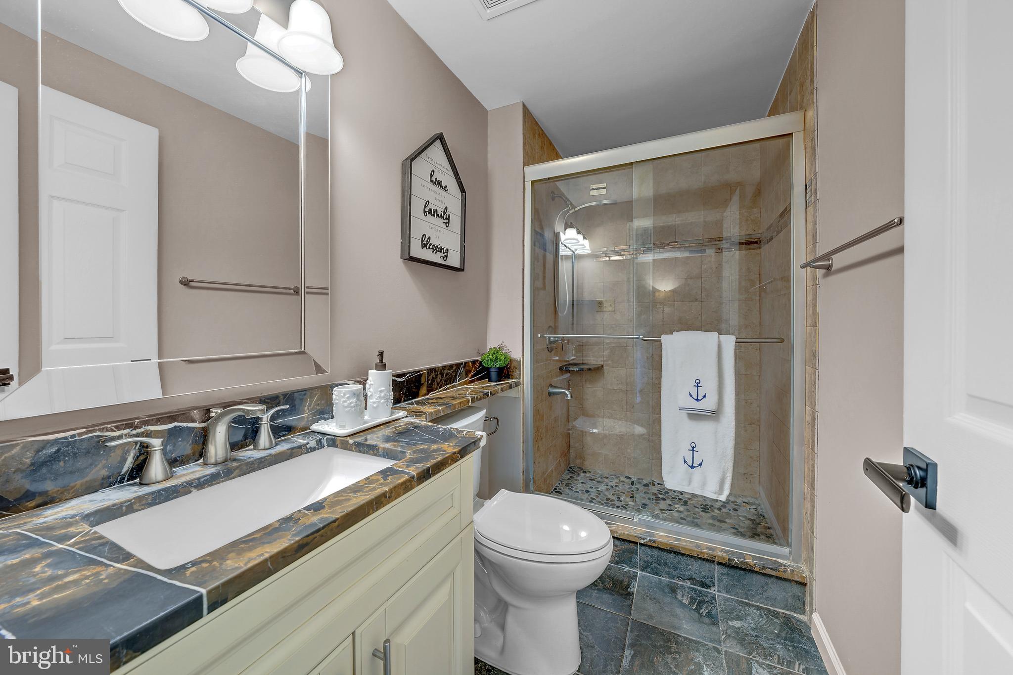 12772 Bradwell Road Herndon, VA 20171 - Photo 23 of 43 a bathroom with a granite countertop sink toilet and shower