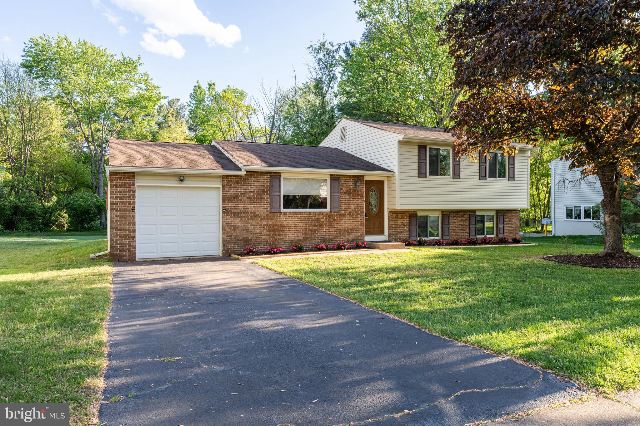 12772 Bradwell Road Herndon, VA 20171 - Photo 3 of 43 a front view of a house with a garden and yard