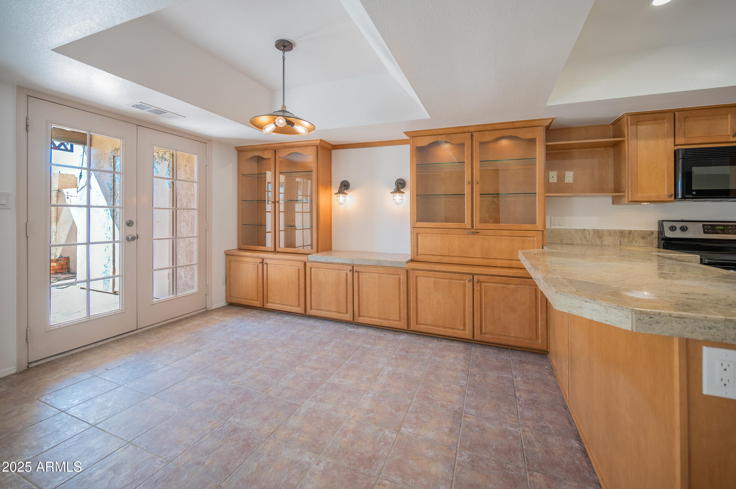 1920 East Maryland Avenue, Unit 31 Phoenix, AZ 85016 - Photo 11 of 43 a large kitchen with granite countertop a sink and white cabinets