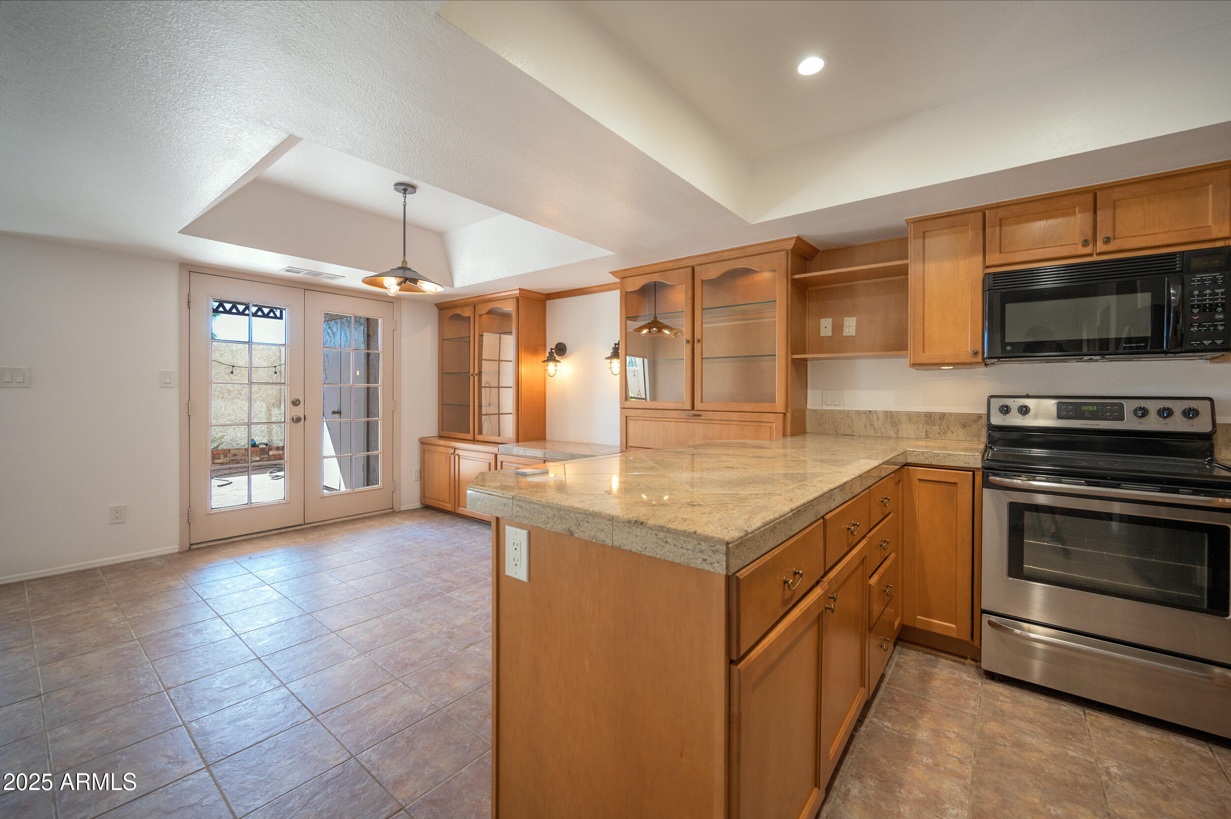 1920 East Maryland Avenue, Unit 31 Phoenix, AZ 85016 - Photo 12 of 43 a kitchen with kitchen island granite countertop a stove and a sink
