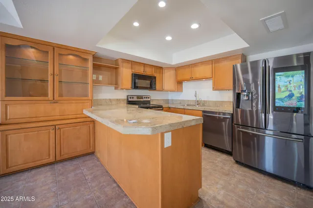 a kitchen with stainless steel appliances granite countertop a sink stove and refrigerator