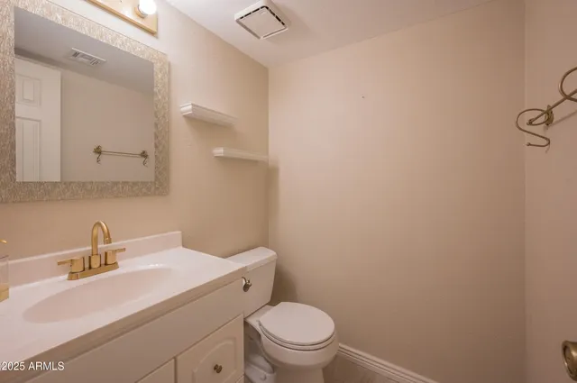 a bathroom with a sink toilet and a mirror