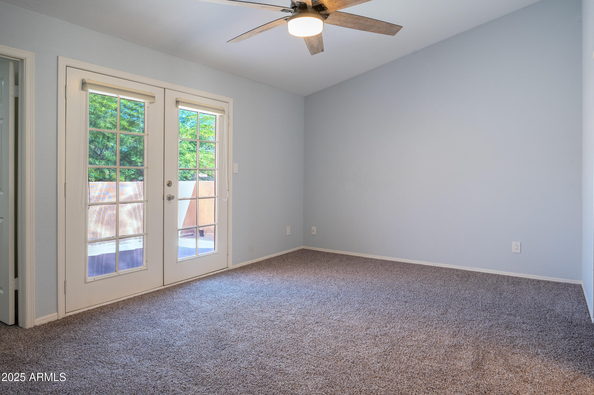 1920 East Maryland Avenue, Unit 31 Phoenix, AZ 85016 - Photo 20 of 43 an empty room with windows and ceiling fan