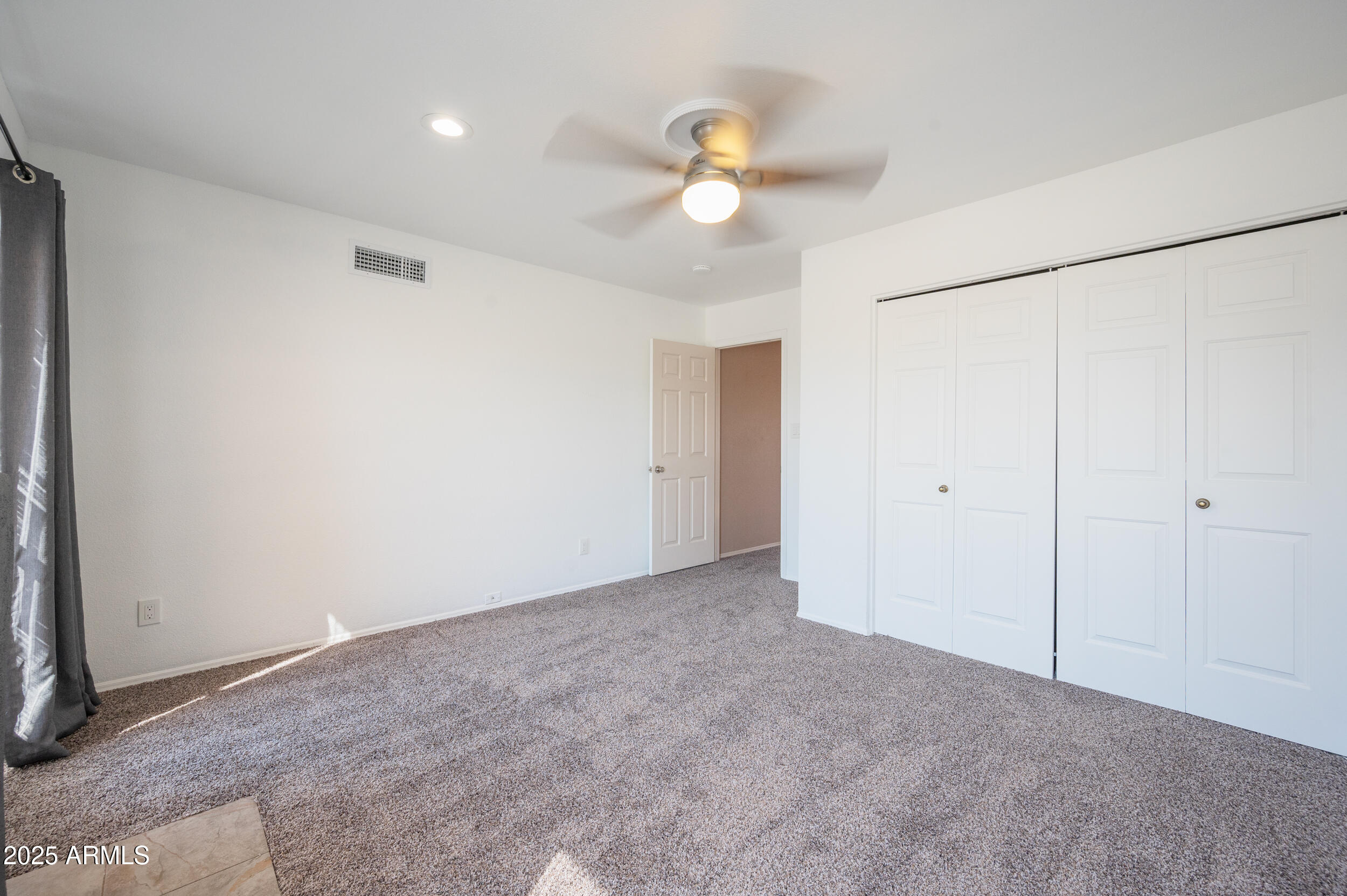 1920 East Maryland Avenue, Unit 31 Phoenix, AZ 85016 - Photo 26 of 43 a view of an empty room with a chandelier fan