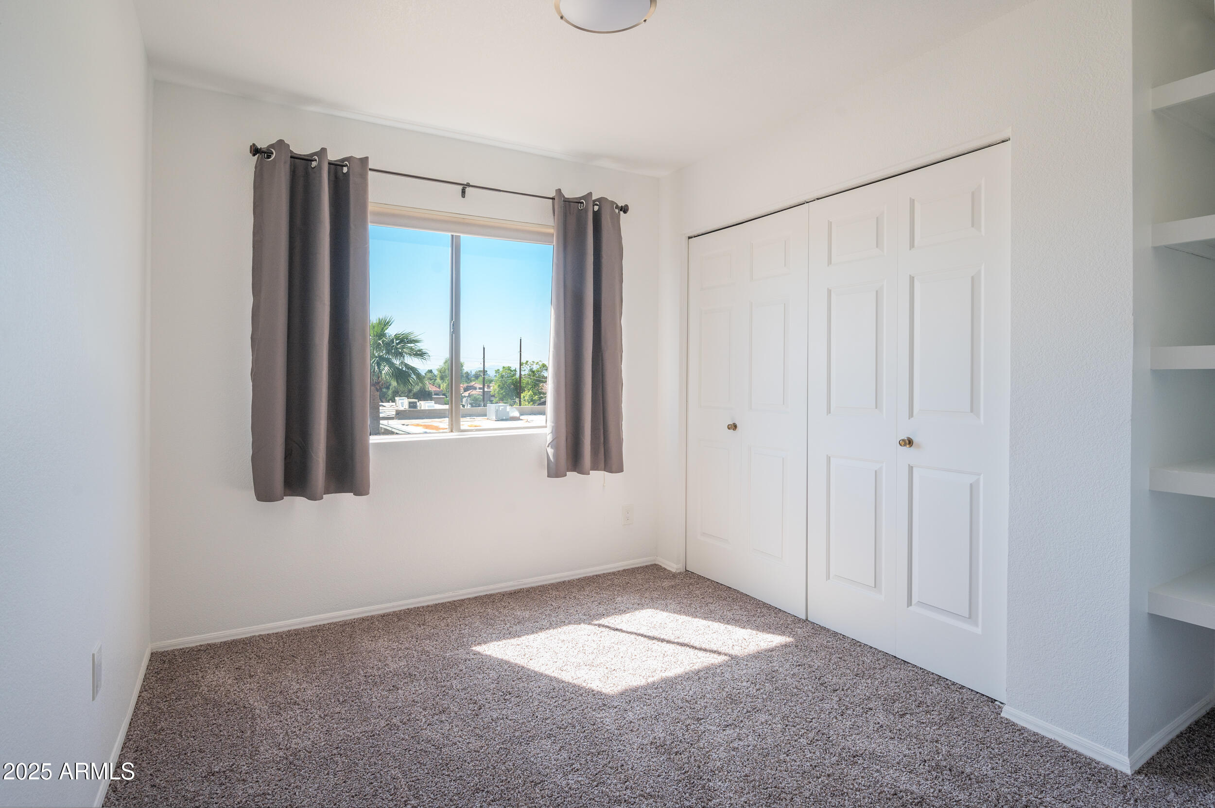 1920 East Maryland Avenue, Unit 31 Phoenix, AZ 85016 - Photo 28 of 43 a view of an empty room with a window