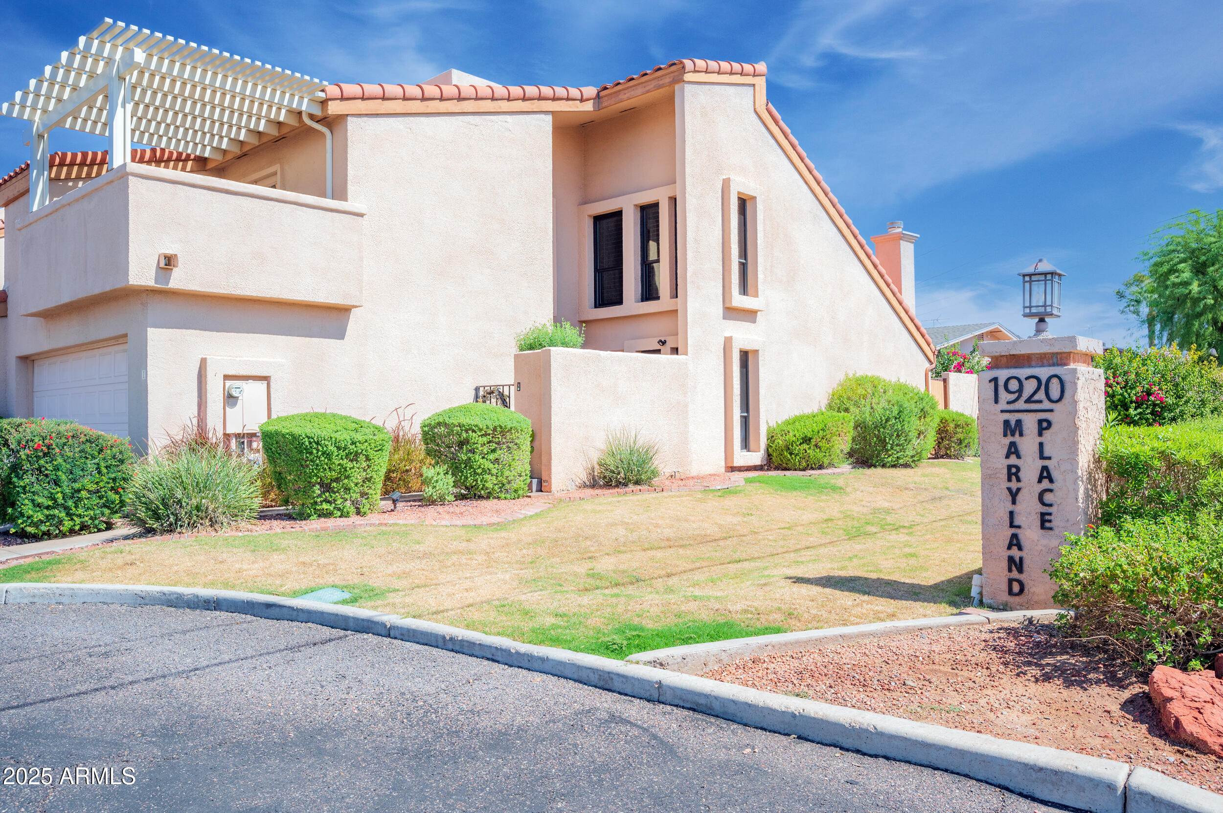 1920 East Maryland Avenue, Unit 31 Phoenix, AZ 85016 - Photo 40 of 43 a front view of a house with a yard and garage
