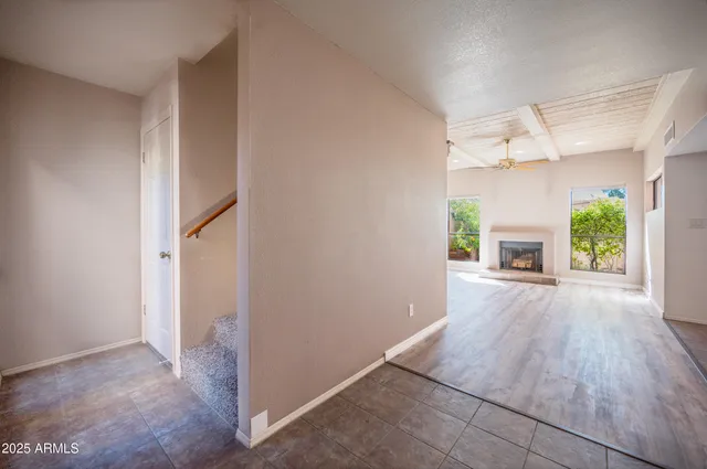 an empty room with windows and a fireplace