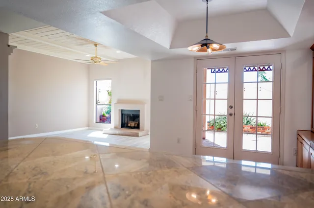 a view of an empty room with a fireplace and a window