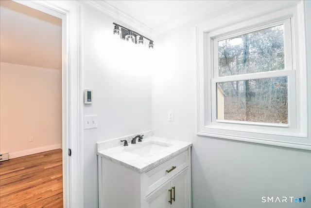 a view of a room with wooden floor and windows