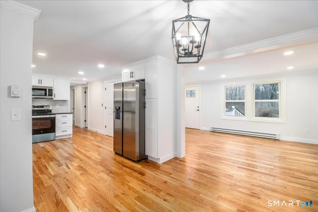 a view of a kitchen with a stove cabinets and wooden floor