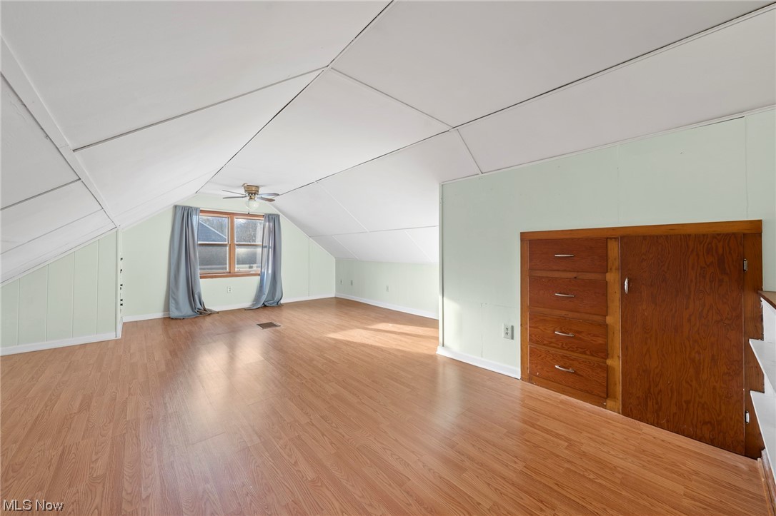 227 South Messner Road New Franklin, OH 44319 - Photo 38 of 44 Bonus room with light wood-type flooring, vaulted ceiling, and ceiling fan