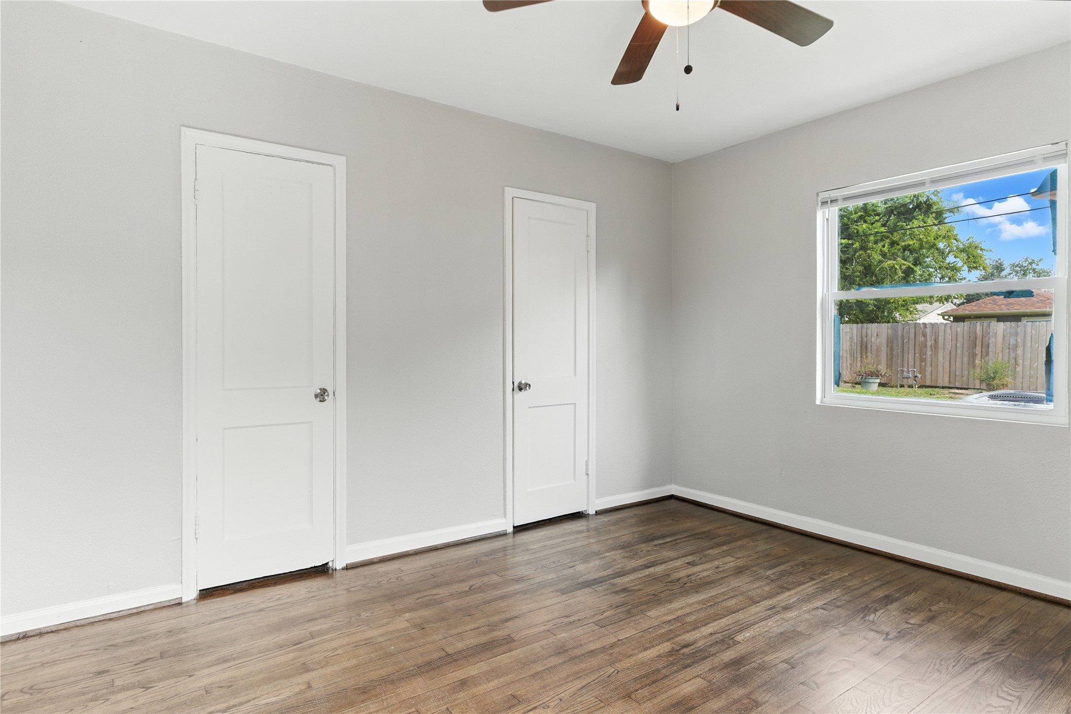 3863 Arbor Street Houston, TX 77004 - Photo 5 of 16 wooden floor in an empty room with a window
