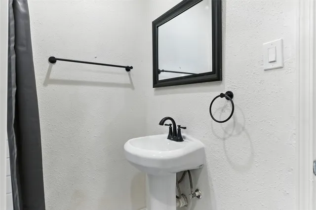 a bathroom with a sink and mirror