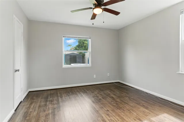 wooden floor in an empty room with a window
