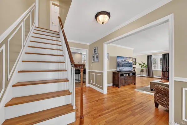 a view of a living room and entryway with wooden floor